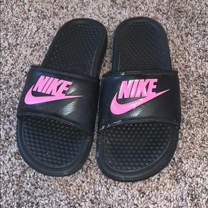 Pink and black Nike slides